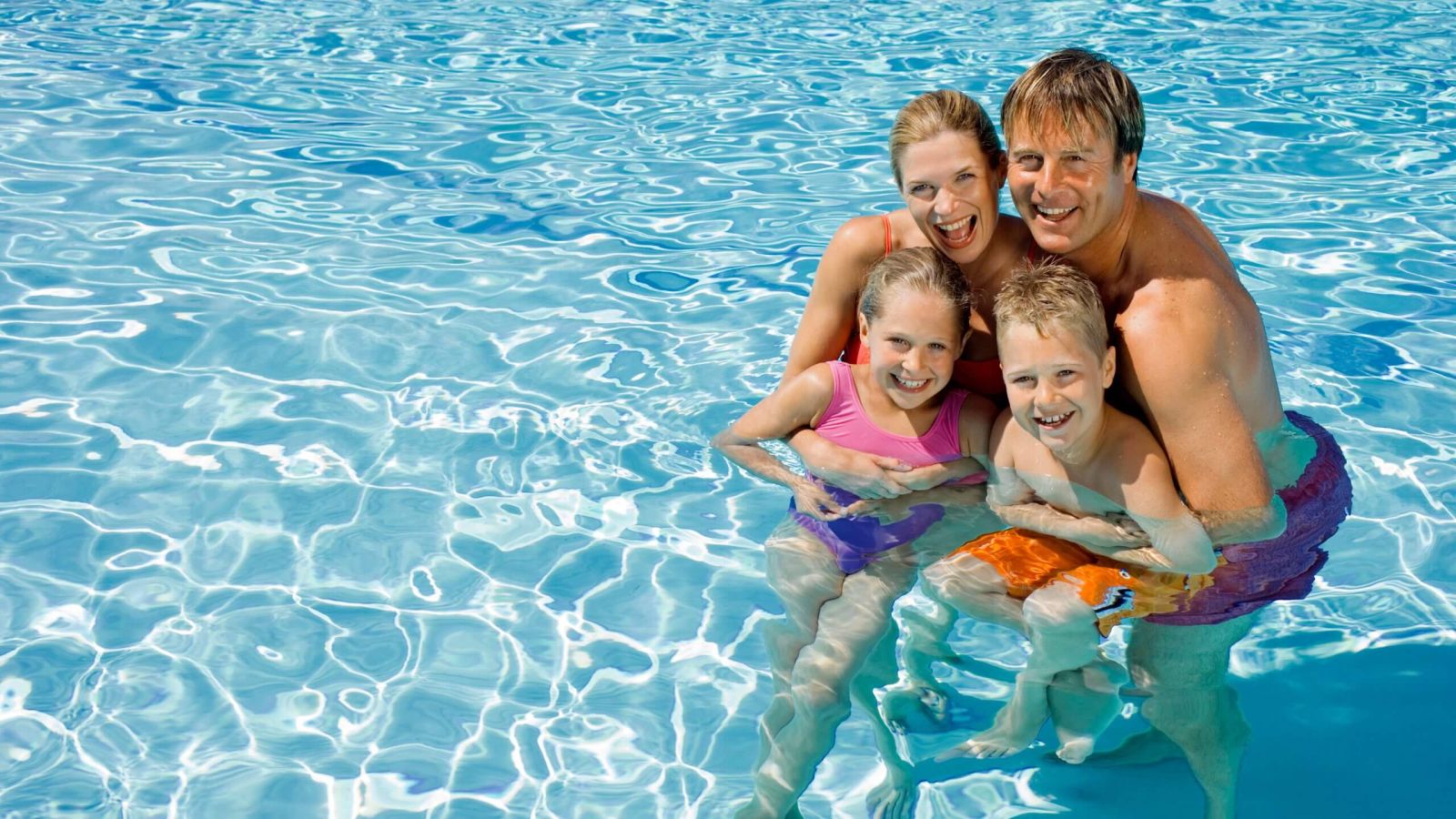 Family enjoying backyard pool