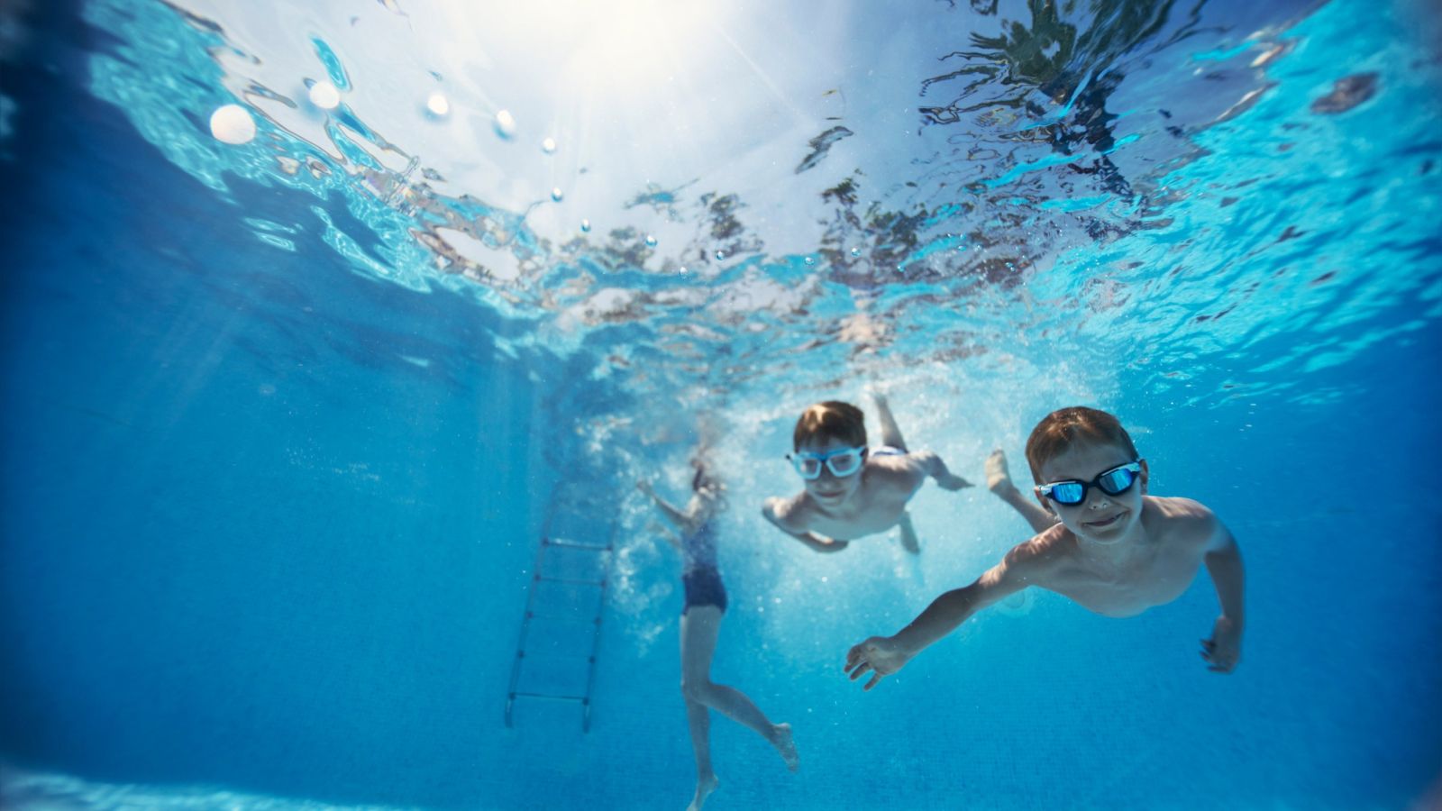 kids underwater in the pool