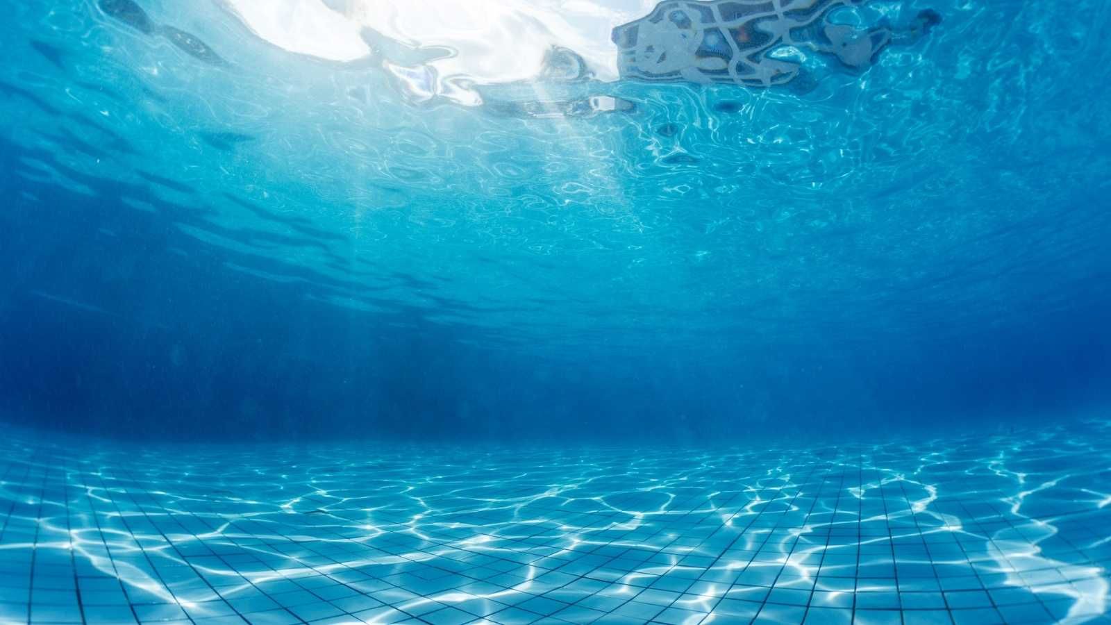 Underneath the water in a pool