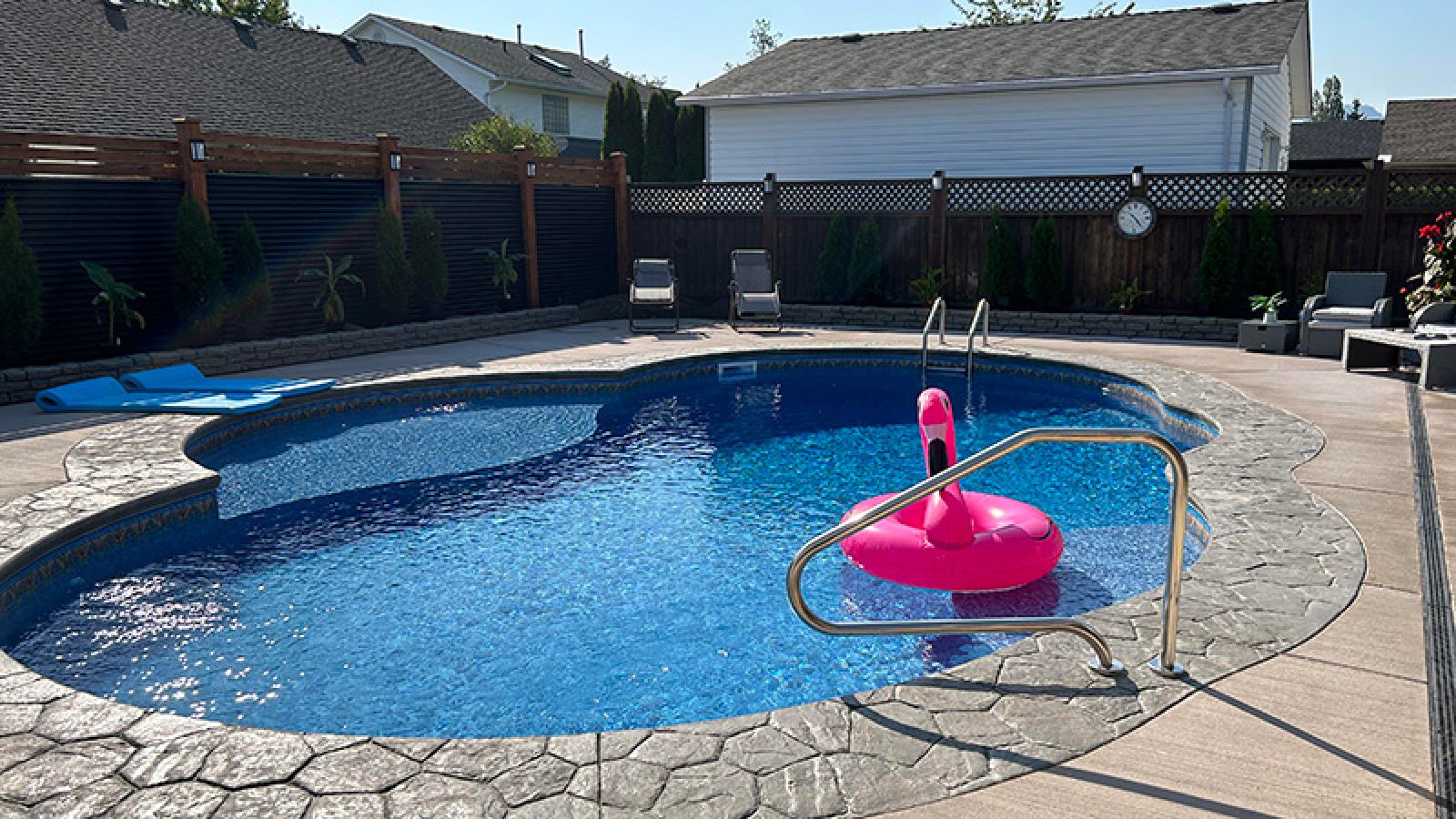 Freeform pool in the backyard of property